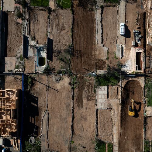 FILE - An aerial view shows houses being rebuilt on cleared lots months after the Palisades Fire, Dec. 5, 2025, in the Pacific Palisades neighborhood of Los Angeles. (AP Photo/Jae C. Hong, File)