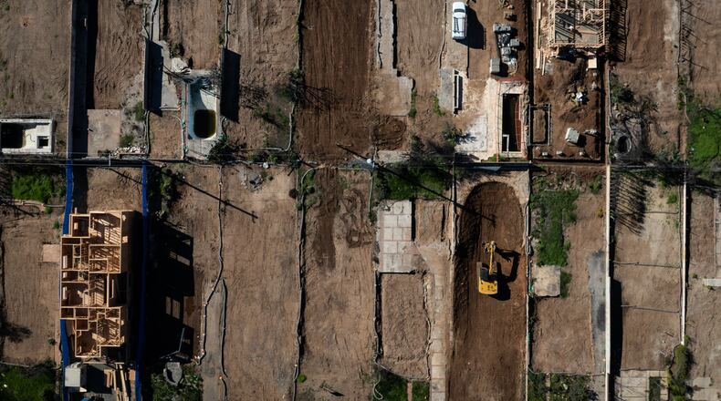 FILE - An aerial view shows houses being rebuilt on cleared lots months after the Palisades Fire, Dec. 5, 2025, in the Pacific Palisades neighborhood of Los Angeles. (AP Photo/Jae C. Hong, File)