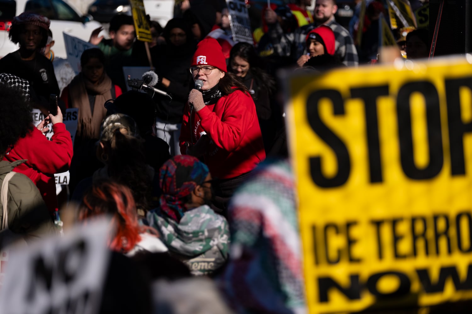 Addison Clapp with the Party for Socialism & Liberation takes to the mic during a protest on the 17th Street Bridge in Atlanta on Sunday, Jan. 11, 2026 against the ICE shooting of Renee Good and the US military action in Venezuela. Ben Gray for the Atlanta Journal-Constitution