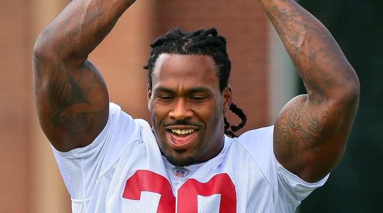 Falcons running back Steven Jackson laughs while reaching up to grab a pass over his head during team practice on Tuesday, June 11 in Flowery Branch. CURTIS COMPTON / CCOMPTON@AJC.COM
