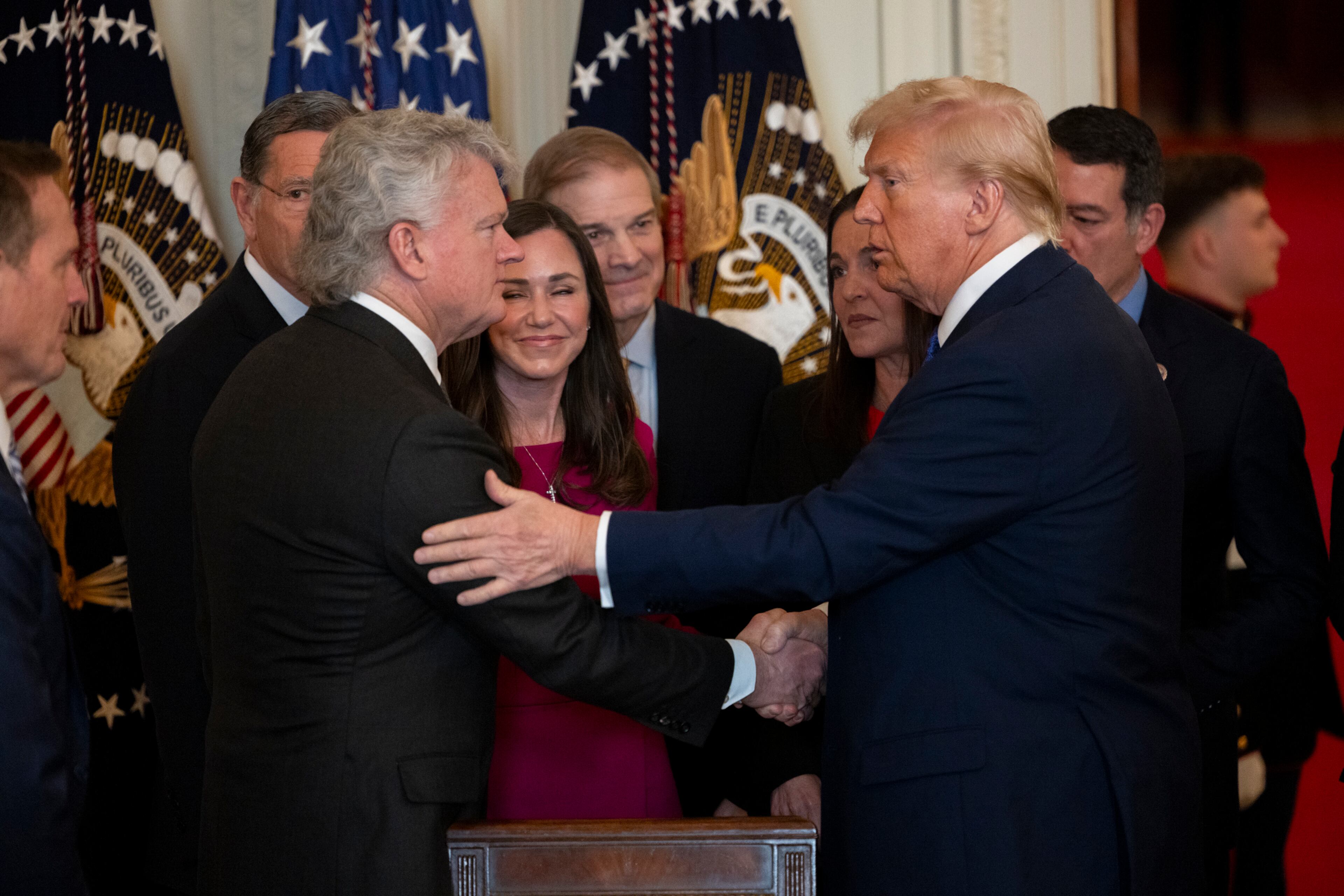 President Donald Trump shakes hands with U.S. Rep. Mike Collins, R-Jackson, after signing the Laken Riley Act at the White House in January.