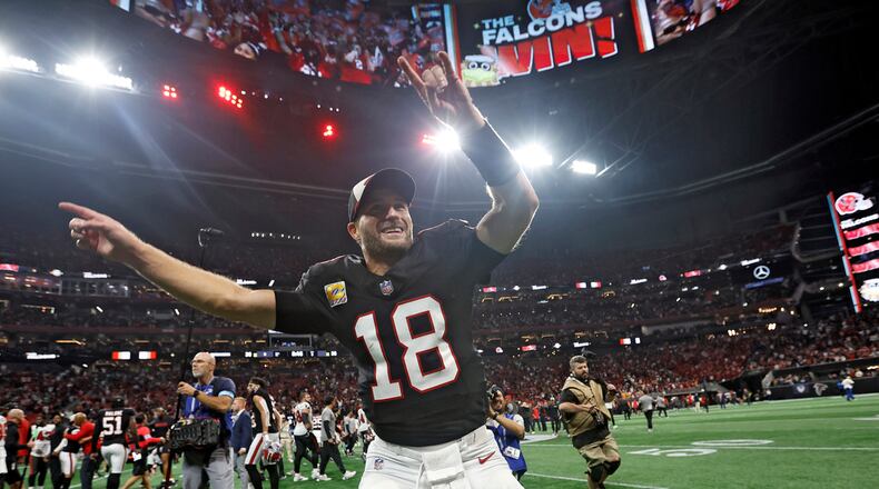Atlanta Falcons quarterback Kirk Cousins (18) celebrates with the fans after the team defeated the Tampa Bay Buccaneers during overtime in an NFL football game Thursday, Oct. 3, 2024, in Atlanta. (AP Photo/Butch Dill)
