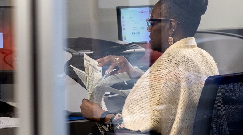 An election workers processes early and mail-in ballots on Nov. 5 at the DeKalb County Voter Registration and Elections Office in Decatur. (Arvin Temkar/The Atlanta Journal-Constitution)