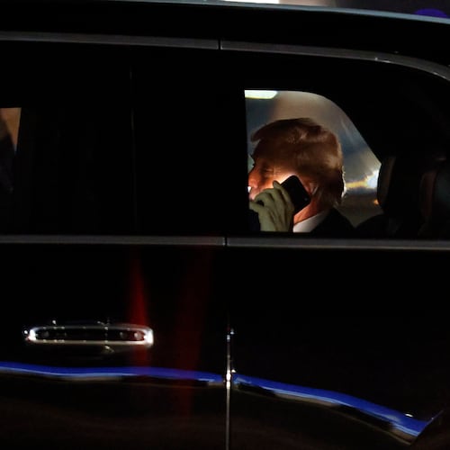 FILE - President Donald Trump talks on his cell phone in his limousine, known as "The Beast," upon his arrival at Joint Base Andrews, Md., March 6, 2026. (AP Photo/Luis M. Alvarez, File)