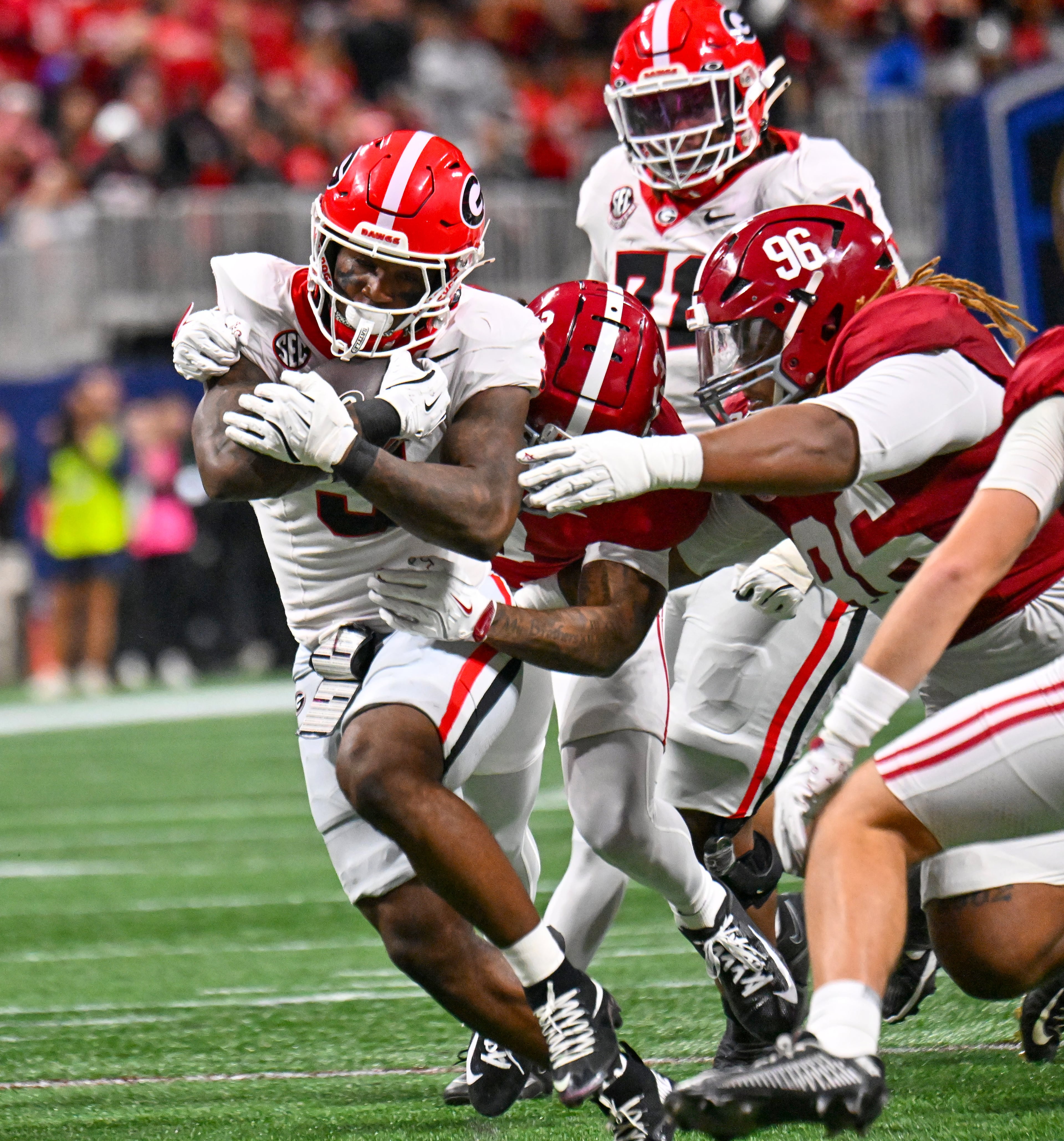 Georgia running back Nate Frazier (3) rushes against Alabama defensive lineman Tim Keenan III (96) during the first quarter of the SEC Championship game at Mercedes-Benz Stadium, Saturday, Dec. 6, 2025, in Atlanta. (Hyosub Shin / AJC)