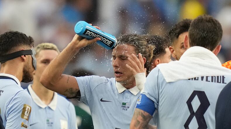 Uruguay's Agustin Canobbio cools off during a hydration break in a World Cup Group H soccer match against Saudi Arabia in Miami Gardens, Fla., Monday, June 15, 2026. (AP Photo/Lynne Sladky)