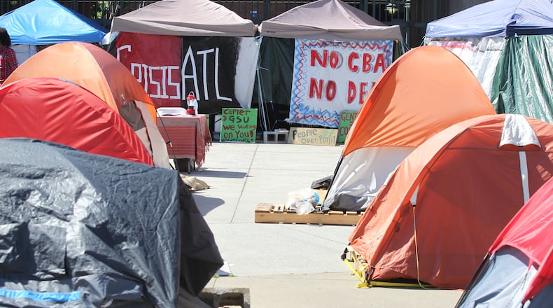 Rows of camping tents set up on top of wooden pallets lie unoccupied at a press conference held by neighborhood residents at Tent City in on April 26, 2017.