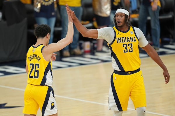 Indiana Pacers center Myles Turner (33) high fives guard Ben Sheppard (26) during the second half of Game 6 of the NBA Finals basketball series against the Oklahoma City Thunder, Thursday, June 19, 2025, in Indianapolis. (AP Photo/Michael Conroy)