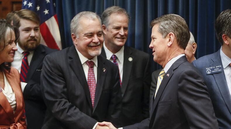 Gov. Brian Kemp greets state school Superintendent Richard Woods on Tuesday, when he announced legislation Tuesday to “reduce high-stakes K-12 testing in Georgia.” Kemp and Woods traveled the state over the summer talking with teachers and parents about the number of tests Georgia’s students take each year, which they say is too many. BOB ANDRES / BANDRES@AJC.COM