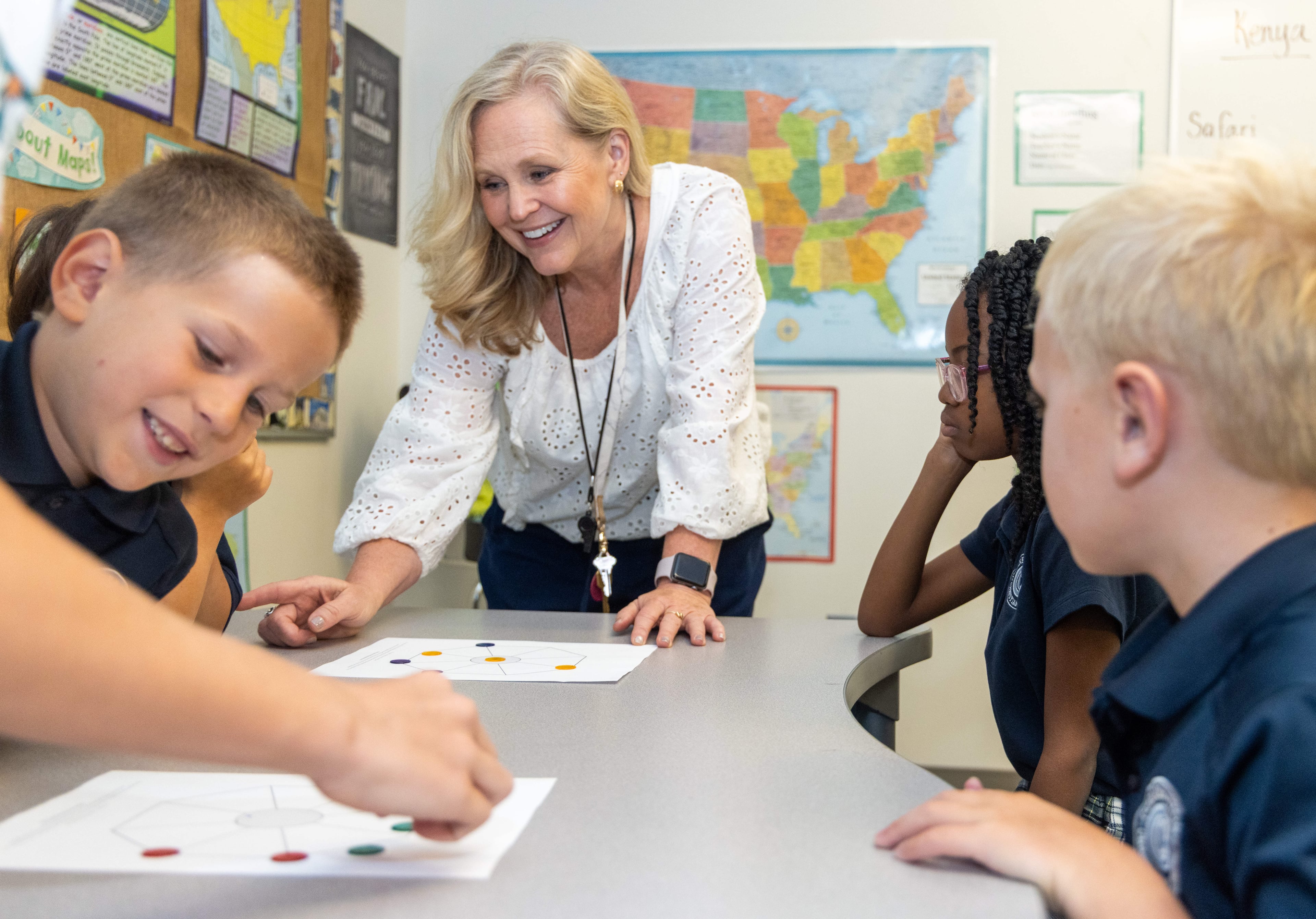 Angie Rodgers helps students in her "Globe Trotters Around the World" class. Teachers at Cornerstone Christian Academy say they are uplifted. (Phil Skinner for the AJC)