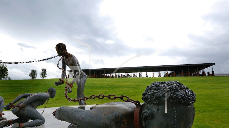 Part of a statue depicting chained people is on display at the National Memorial for Peace and Justice, a new memorial to honor thousands of people killed in racist lynchings, Sunday, April 22, 2018, in Montgomery, Ala. The national memorial aims to teach about America's past in hope of promoting understanding and healing. It's scheduled to open on Thursday. (AP Photo/Brynn Anderson)