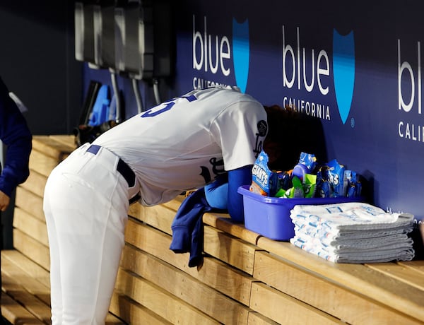 Los Angeles Dodgers' Dustin May hangs his head in the dugout after striking out the side against the Atlanta Braves during the first inning of a baseball game Tuesday, April 1, 2025, in Los Angeles. (AP Photo/Kevork Djansezian)