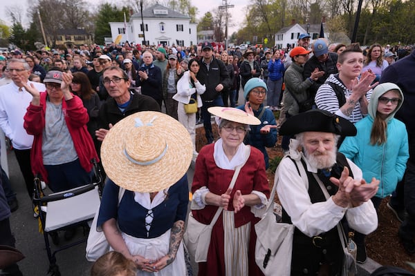 Thousands, some dressed in period clothing, watch a reenactment celebration of the 250th anniversary of the Battle of Lexington and start of the American Revolution, Saturday, April 19, 2025, in Lexington, Mass. (AP Photo/Charles Krupa)