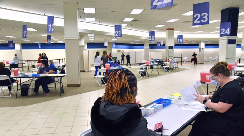 February 5, 2021 Duluth - Healthcare workers prepare at vaccination area ahead of the opening of the mass COVID-19 vaccination center at the former Sears building in Gwinnett Place Mall in Duluth on Friday, February 5, 2021. Gwinnett County Government and the Gwinnett, Newton and Rockdale County Health Departments worked together to convert the bottom floor of the former Sears building at Gwinnett Place Mall into a mass vaccination center that will accommodate immunizing up to 3,000 people a day as vaccines become available. (Hyosub Shin / Hyosub.Shin@ajc.com)