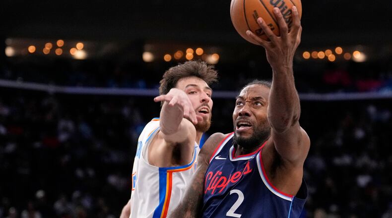 Los Angeles Clippers forward Kawhi Leonard, right, shoots as Oklahoma City Thunder center Chet Holmgren defends during the second half of an NBA basketball game Wednesday, April 8, 2026, in Inglewood, Calif. (AP Photo/Mark J. Terrill)