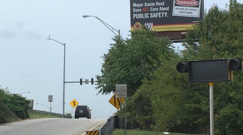 Atlanta police and fire unions are behind this billboard near Turner Field blasting Mayor Kasim Reed over pay. Reed has refused to give raises to sworn officers as long as the city remains embroiled in a lawsuit the unions support that threatens his 2011 pension reform. (KATIE LESLIE / KLESLIE@AJC.COM)