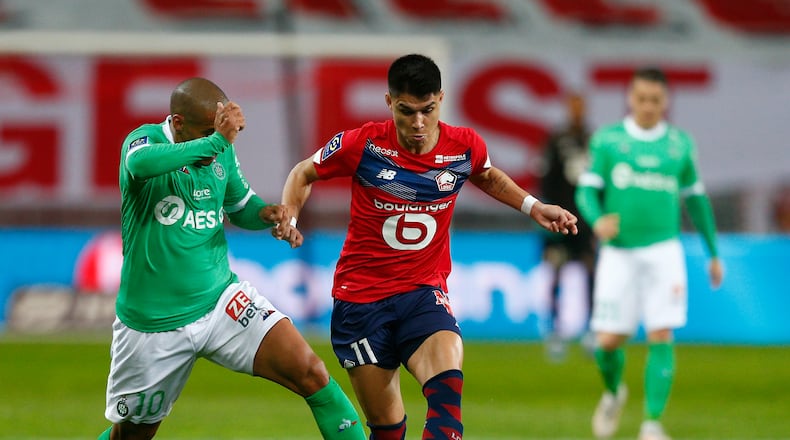 Saint-Etienne's Wahbi Khazri, left challenges Lille's Luiz Araujo for the ball during the French League One soccer match between Lille and Saint-Etienne in Lille, France, on Sunday, May 16, 2021. (AP Photo/Michel Springler)