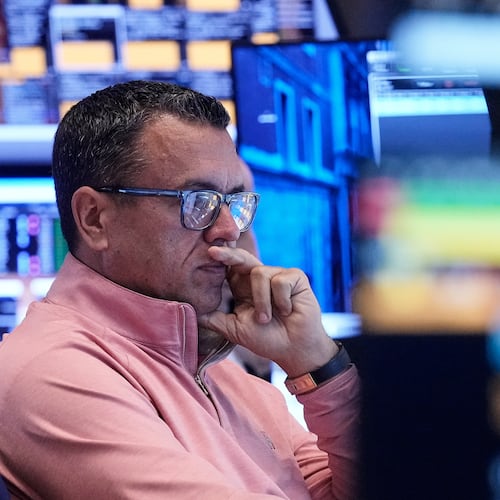 Trader Robert Finnerty Jr. works on the floor of the New York Stock Exchange, Friday, Nov. 21, 2025. (AP Photo/Richard Drew)