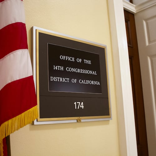 An American flag stands outside the office of California's 14th Congressional District in the Cannon House Office Building in Washington, Monday, July 20, 2026. (AP Photo/Tallulah Brown Van Zee)