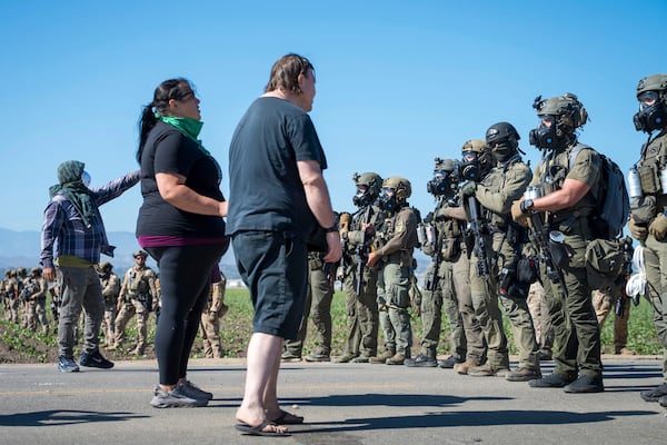 Protesters standoff against federal immigration agents during a raid in the agriculture area of Camarillo, Calif., Thursday, July 10, 2025. (AP Photo/Michael Owen Baker)