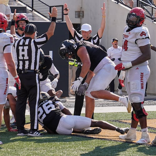 Officials signal touchdown after Vanderbilt cornerback Cayden Daniels (26) recovered a North Carolina State fumble in the end zone during the second half of an NCAA college football game Saturday, Sept. 19, 2026, in Nashville, Tenn. (AP Photo/George Walker IV)