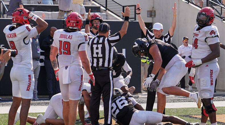 Officials signal touchdown after Vanderbilt cornerback Cayden Daniels (26) recovered a North Carolina State fumble in the end zone during the second half of an NCAA college football game Saturday, Sept. 19, 2026, in Nashville, Tenn. (AP Photo/George Walker IV)