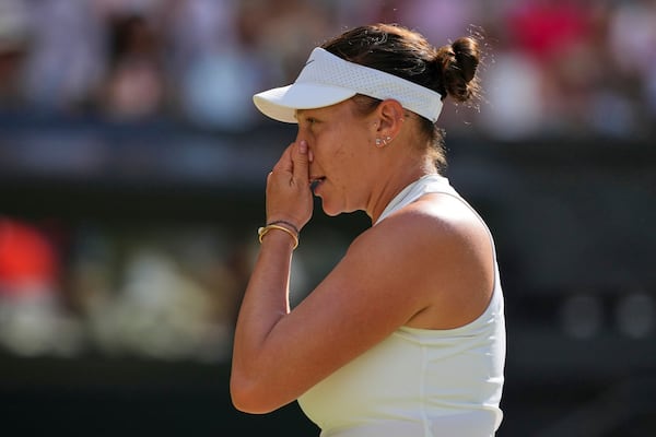 Amanda Anisimova of the U.S. reacts as she plays Poland's Iga Swiatek during the women's singles final at the Wimbledon Tennis Championships in London, Saturday, July 12, 2025. (AP Photo/Kin Cheung)
