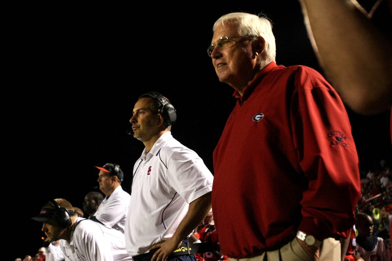 Sandy Creek coach Chip Walker (center) and former Sandy Creek coach and Chip's father Rodney Walker (right) stand next to each other on the sideline during Sandy Creek's win over Eastside at Sandy Creek H.S. Friday night in Tyrone, Ga., Oct. 01, 2010. Sandy Creek is ranked No. 2 in Class AAA. Rodney and his son Chip are the only father son in Georgia state history to both win football state championships as head coaches. (Jason Getz/AJC)