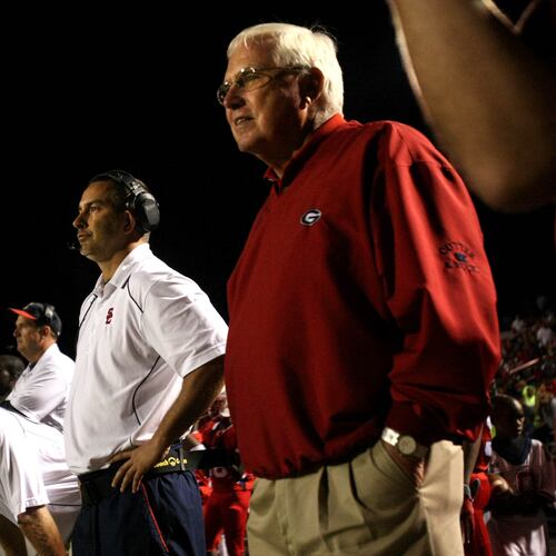 Sandy Creek coach Chip Walker (center) and former Sandy Creek coach and Chip's father Rodney Walker (right) stand next to each other on the sideline during Sandy Creek's win over Eastside at Sandy Creek H.S. Friday night in Tyrone, Ga., Oct. 01, 2010. Sandy Creek is ranked No. 2 in Class AAA. Rodney and his son Chip are the only father son in Georgia state history to both win football state championships as head coaches. (Jason Getz/AJC)