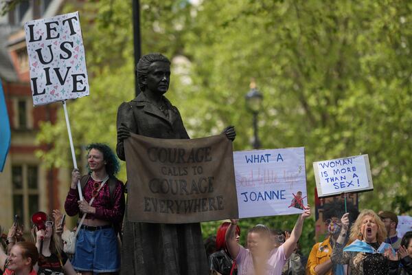 Campaigners take part in a rally organised by trans rights groups, trade unions, and community organisations following the Supreme Court ruling on the definition of a woman in equalities law, at Parliament Square, central London, Saturday April 19, 2025. (AP Photo/Alastair Grant)