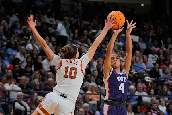 TCU guard Donovyn Hunter (4) shoots against Texas guard Shay Holle (10) during the second half in the Elite Eight of the NCAA college basketball tournament, Monday, March 31, 2025. in Birmingham, Ala. (AP Photo/Gerald Herbert)