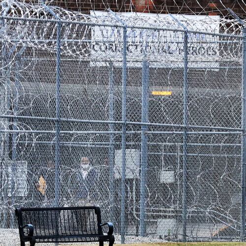 Devonia Inman (center wearing mask) is led past rows of barbed wire to freedom out of the Augusta State Medical Prison after being released from custody after serving 23 years in prison for a wrongful conviction on Monday, Dec 20, 2021, in Grovetown. His charges were dismissed in a murder case. (AJC file photo)