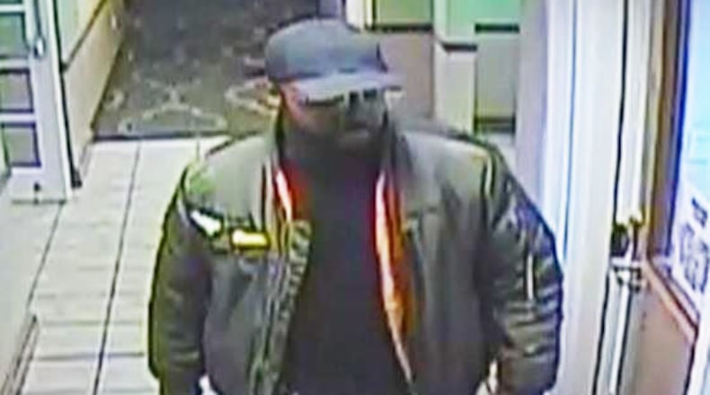 DeKalb County police say this man is a person of interest after a woman was strangled to death in a hotel room. (Credit: DeKalb police)