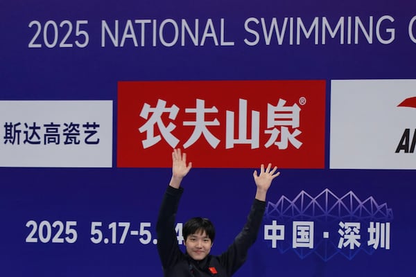 In this photo taken May 24, 2025 and released by Hebei Taihua Jinye Swimming Club, 12 years old Chinese swimmer Yu Zidi celebrates on the podium of the 2025 National Swimming Championships after competing in the Women's 400m Individual Medley event in Shenzhen in southern China's Guangdong province.(Hebei Taihua Jinye Swimming Club via AP)