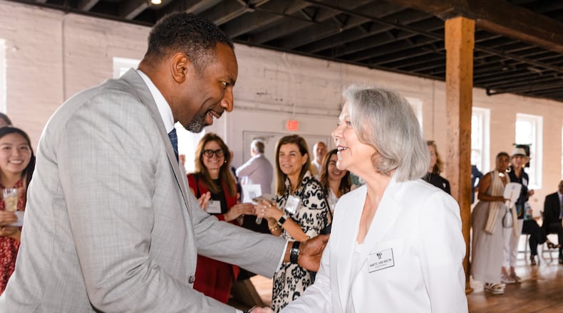 Mayor Andre Dickens (left) with Annette Cone-Skelton, the Museum of Contemporary Art of Georgia's founder and CEO, shake hands during the announcement of the city of Atlanta's contribution to the visual art institution's Grounded building campaign. Courtesy of Dustin Chambers