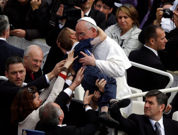 FILE - Pope Francis hugs 8-year-old Dominic Gondreau, who has cerebral palsy, after celebrating his first Easter Mass in St. Peter's Square at the Vatican. Sunday, March 31, 2013. (AP Photo/Gregorio Borgia, File)