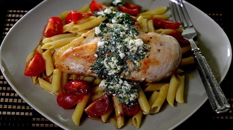Golden brown chicken breasts top pasta with a goat cheese vinaigrette. (Diedra Laird/Charlotte Observer/TNS)