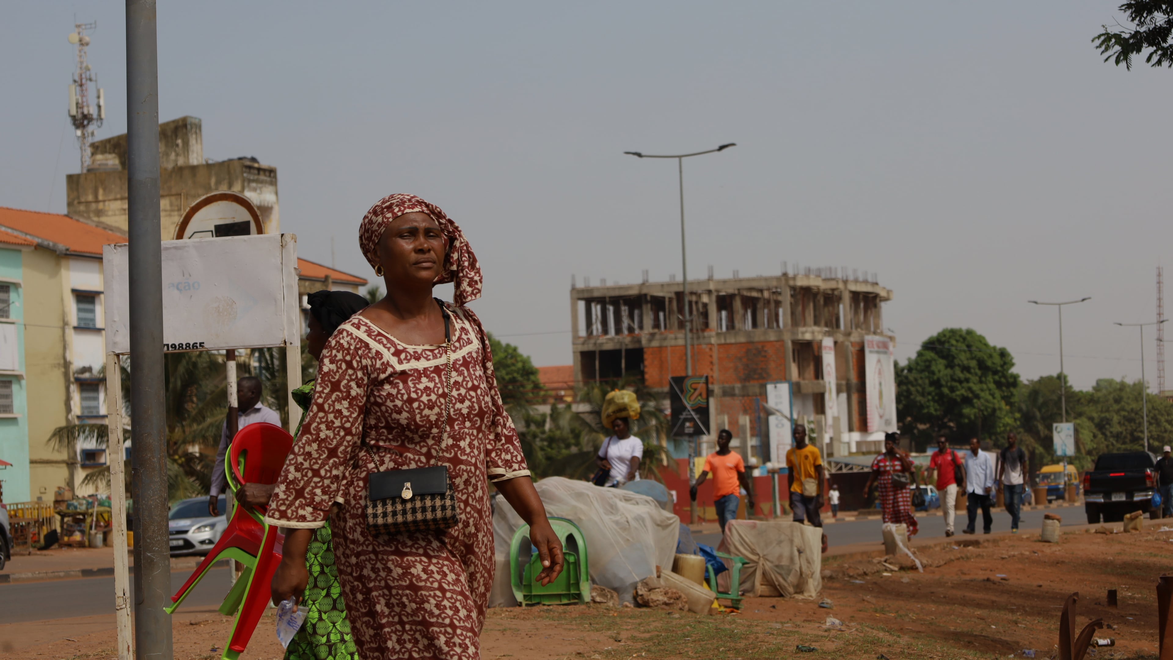 People walk on the street in Bissau, Guinea-Bissau, Wednesday, Nov. 26, 2025. (AP Photo/Darcicio Barbosa)