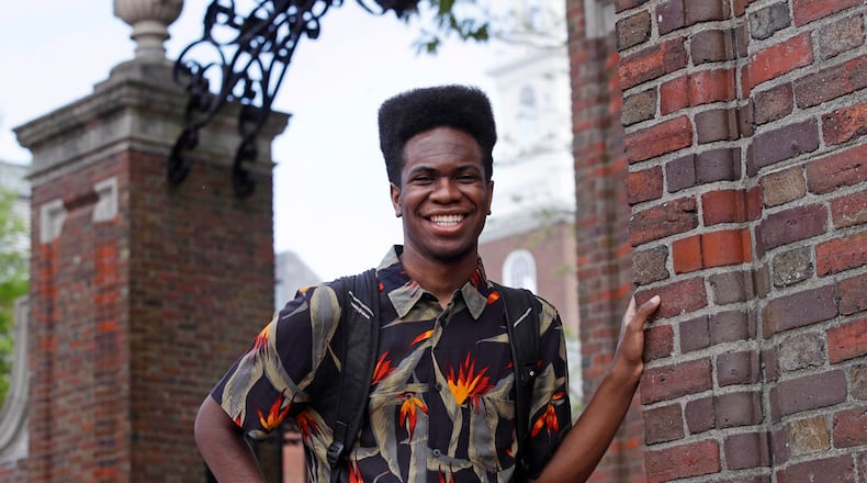 Obasi Shaw poses outside the gates of Harvard Yard in Cambridge, Mass., Thursday, May 18, 2017. Shaw, an English major who graduates from Harvard next week, is the university's first student to submit his final thesis in the form of a rap album. The record, called “Liminal Minds,†has earned the equivalent of an A- grade, good enough to ensure that Shaw will graduate with honors at the university's commencement next week.
