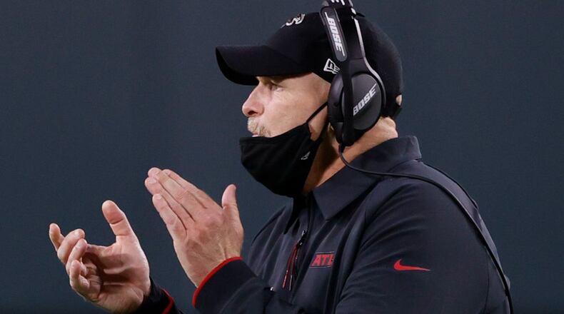 Falcons coach Dan Quinn encourages his team during the second half of Monday's loss at Green Bay. (AP/Tom Lynn)
