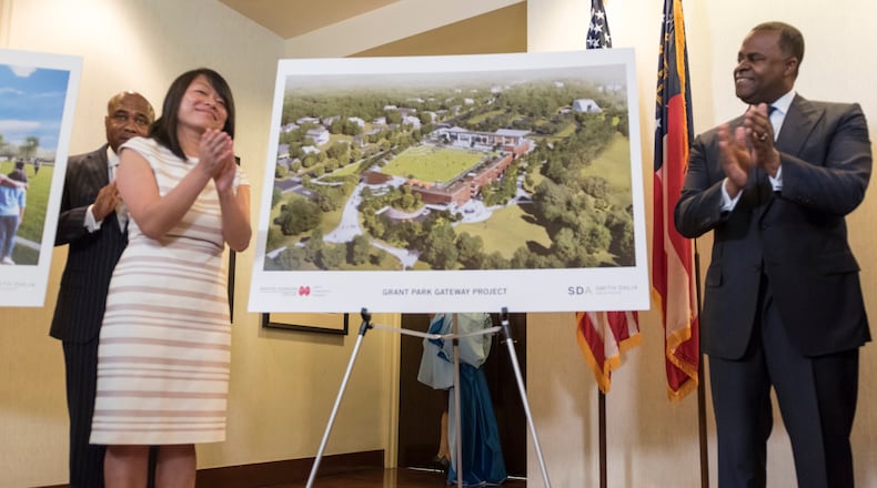 Mayor Kasim Reed and Atlanta Parks and Recreation Commissioner Amy Phuong, left, applaud after revealing renderings of new Grant Park Gateway Project, a 1,000-space parking garage, greenspace and restaurant on Tuesday.