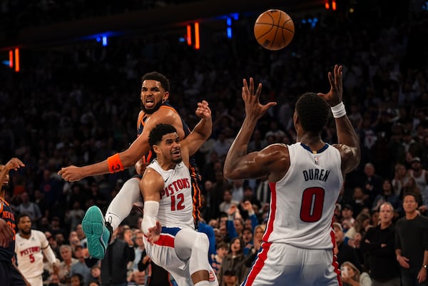 New York Knicks center Karl-Anthony Towns, top left, loses the ball to Detroit Pistons center Jalen Duren (0) at the end of Game 2 of an NBA basketball first-round playoff series, Monday, April 21, 2025, in New York. (AP Photo/Angelina Katsanis)