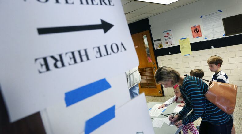 Nov. 3, 2015 - DeKalb County - Helen Garner signs in at Hawthorne Elementary, where city hood for LaVista Hills was on the ballot, with 275 voters by 11am. She said she voted yes for city hood and for ethics reform. DeKalb County residents could vote on an ethics overhaul for the county and city hood for LaVista Hills and Tucker. Hawthorne Elementary is one of the busiest precincts in DeKalb, where voters will consider overhauling the county's ethics rules and city hood for LaVista Hills. BOB ANDRES / BANDRES@AJC.COM