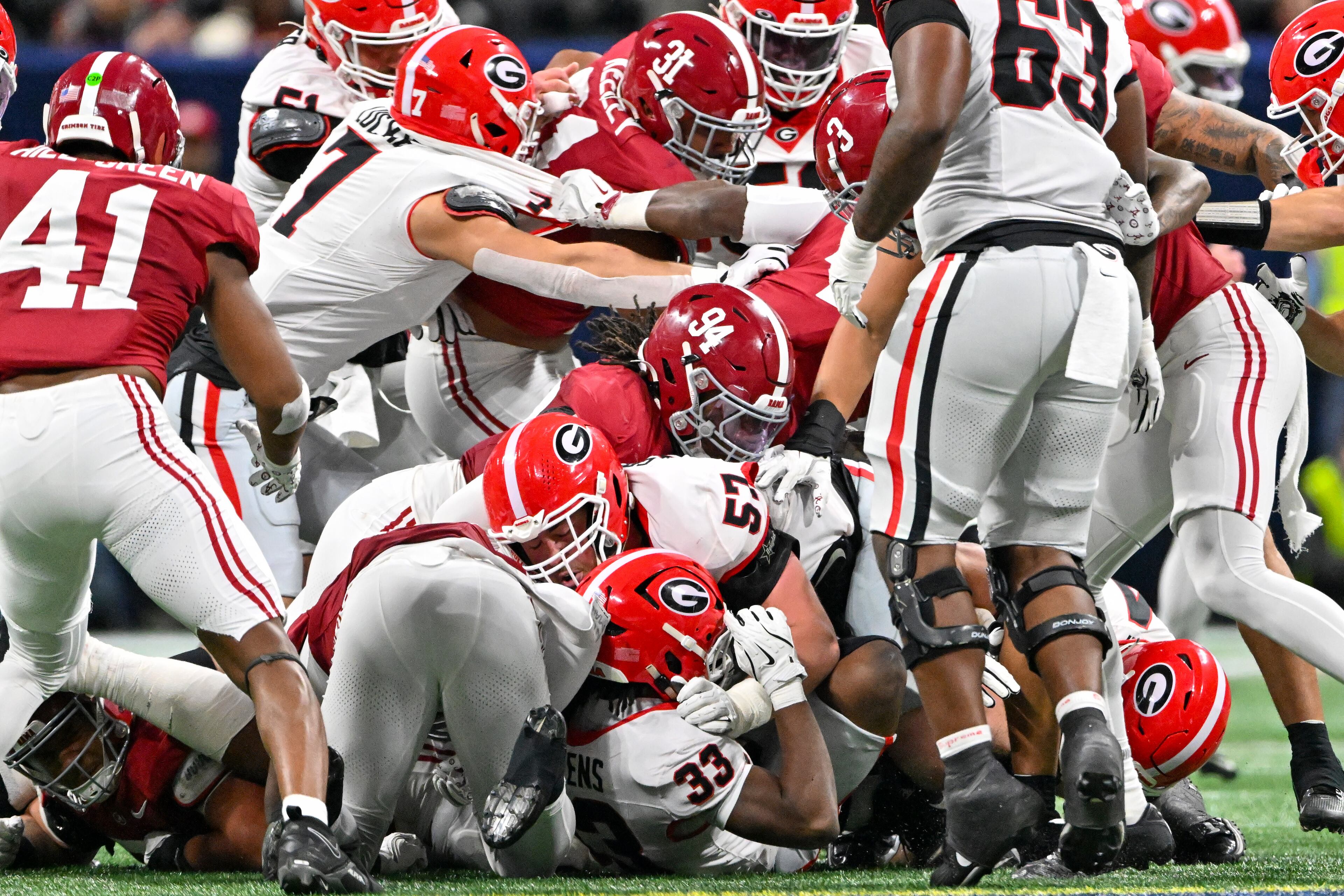 Georgia running back Chauncey Bowens (33) struggles for extra yardage under the Alabama defense during the second quarter of the SEC Championship game at Mercedes-Benz Stadium, Saturday, Dec. 6, 2025, in Atlanta. (Hyosub Shin / AJC)