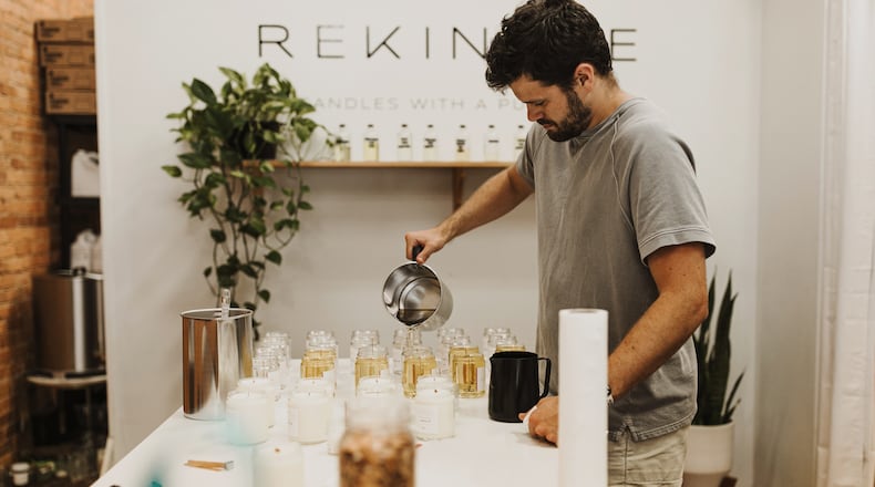 With so many people spending more time in their homes, the urge for comforting ambience has boosted the demand for scented candles. Here, Matt Mewbourne, owner of Rekindle Candle Co. in Monroe, pours candle wax, a mixture of soy wax and coconut oil that hardens overnight to produce a batch of candles.