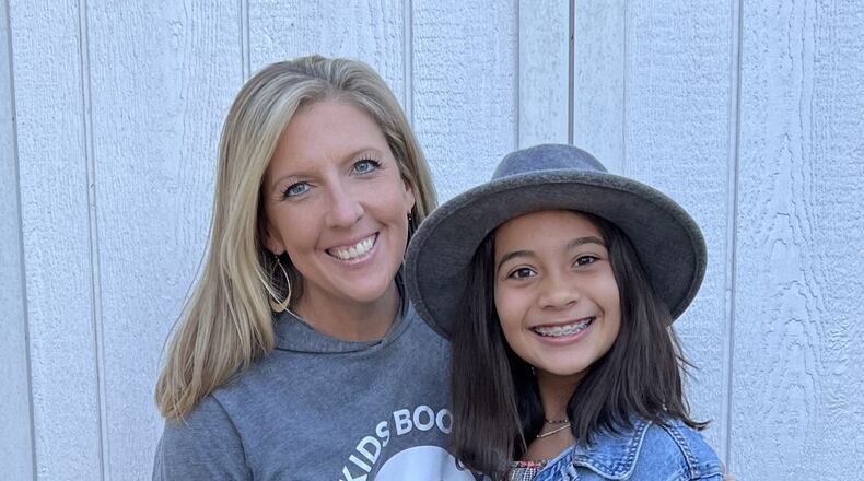 Kids Boost executive director Kristen Williams smiles with Thalia Fung-a-wing, a 12-year-old booster who raised over $1,300 for the End It Movement. Courtesy of Allison May Photography