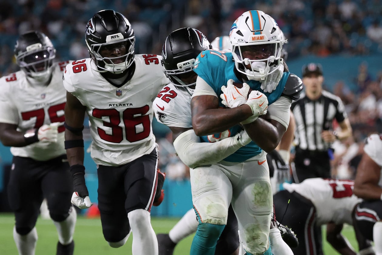 Falcons defensive back Malcolm DeWalt IV (second from left) runs after Miami Dolphins running back Carlos Washington Jr. (foreground) during the second half of an NFL preseason game, Friday, Aug. 28, 2026, in Miami Gardens, Fla. He secured a spot on the Falcons roster over eight players with more NFL experience. (David Santiago/AP)
