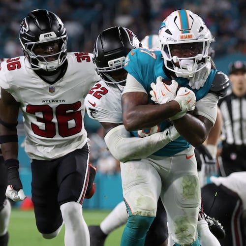 Falcons defensive back Malcolm DeWalt IV (second from left) runs after Miami Dolphins running back Carlos Washington Jr. (foreground) during the second half of an NFL preseason game, Friday, Aug. 28, 2026, in Miami Gardens, Fla. He secured a spot on the Falcons roster over eight players with more NFL experience. (David Santiago/AP)