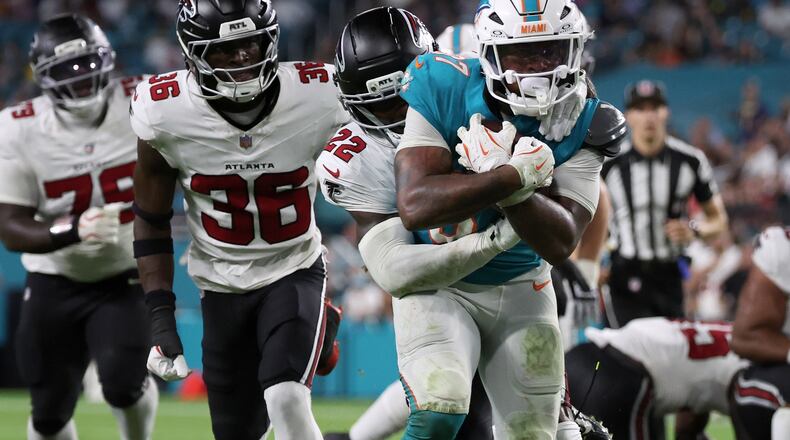 Falcons defensive back Malcolm DeWalt IV (second from left) runs after Miami Dolphins running back Carlos Washington Jr. (foreground) during the second half of an NFL preseason game, Friday, Aug. 28, 2026, in Miami Gardens, Fla. He secured a spot on the Falcons roster over eight players with more NFL experience. (David Santiago/AP)
