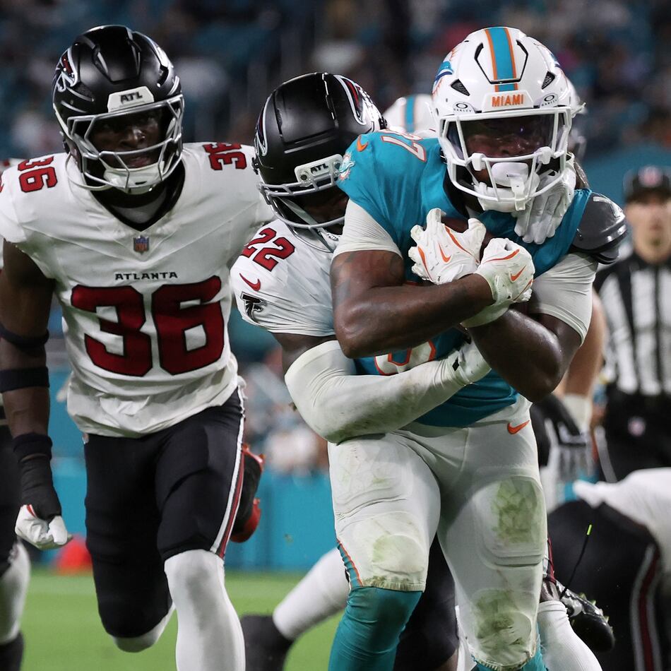 Falcons defensive back Malcolm DeWalt IV (second from left) runs after Miami Dolphins running back Carlos Washington Jr. (foreground) during the second half of an NFL preseason game, Friday, Aug. 28, 2026, in Miami Gardens, Fla. He secured a spot on the Falcons roster over eight players with more NFL experience. (David Santiago/AP)